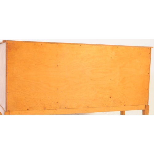 674 - British Modern Design - A vintage 20th century oak sideboard credenza. Of rectangular form with flar... 