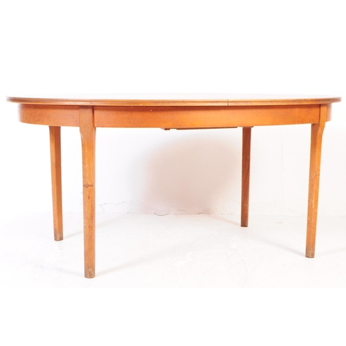 676 - William Lawrence - Mid century teak extending dining table. Of oval form with tapering leg supports.... 