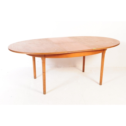 676 - William Lawrence - Mid century teak extending dining table. Of oval form with tapering leg supports.... 