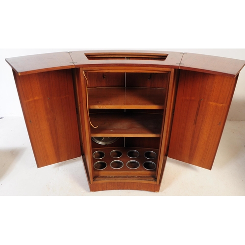 679 - British Modern Design - A mid 20th century teak drinks / cocktail cabinet. Twin front doors with fla... 