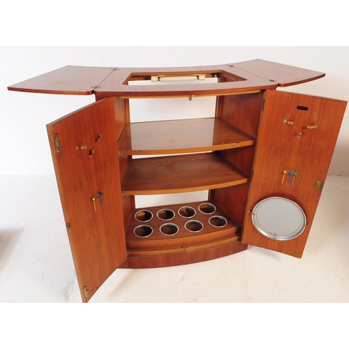 679 - British Modern Design - A mid 20th century teak drinks / cocktail cabinet. Twin front doors with fla... 