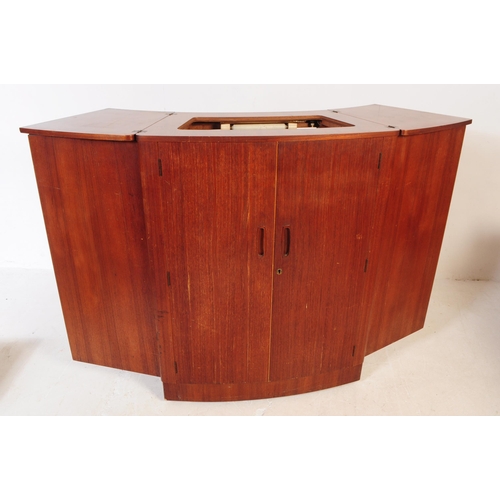 679 - British Modern Design - A mid 20th century teak drinks / cocktail cabinet. Twin front doors with fla... 