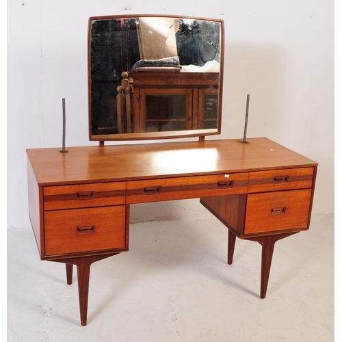 683 - British Modern Design - Mid 20th century teak dressing table. Rectangular form with knee hole to cen... 