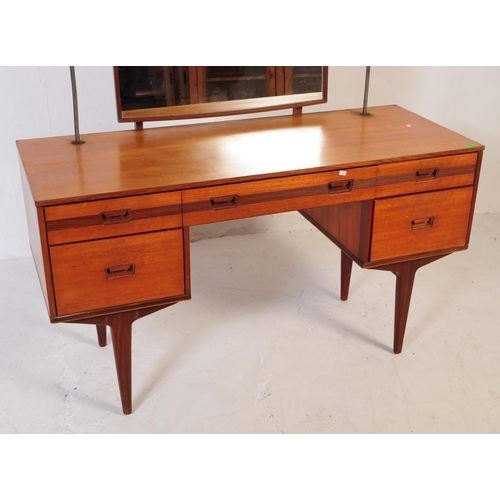 683 - British Modern Design - Mid 20th century teak dressing table. Rectangular form with knee hole to cen... 