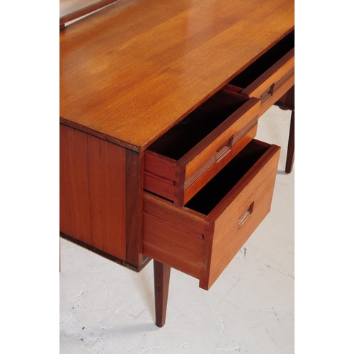 683 - British Modern Design - Mid 20th century teak dressing table. Rectangular form with knee hole to cen... 