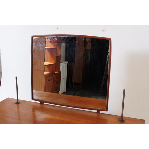 683 - British Modern Design - Mid 20th century teak dressing table. Rectangular form with knee hole to cen... 