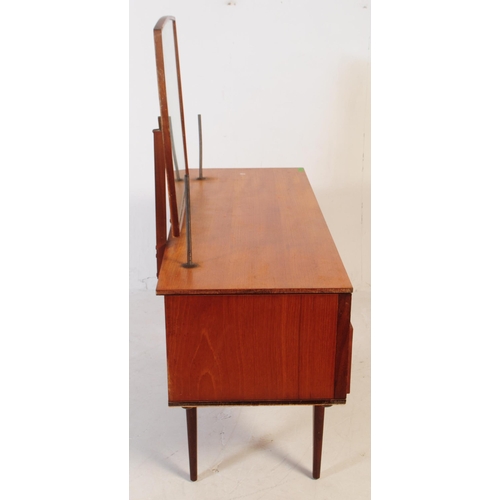 683 - British Modern Design - Mid 20th century teak dressing table. Rectangular form with knee hole to cen... 