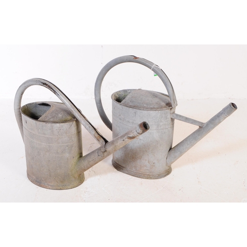 705 - A collection of mid 20th century galvanised bath/planters & watering cans. To include three oval gal... 