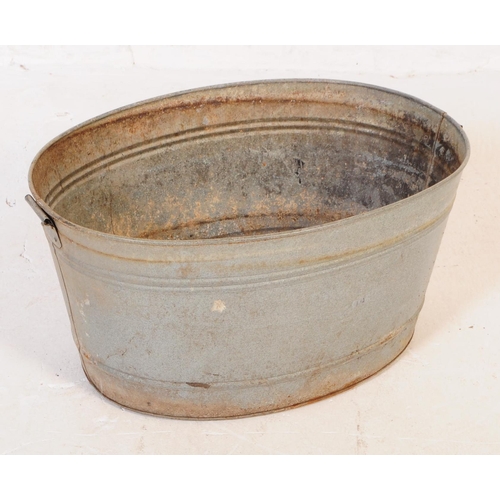 705 - A collection of mid 20th century galvanised bath/planters & watering cans. To include three oval gal... 