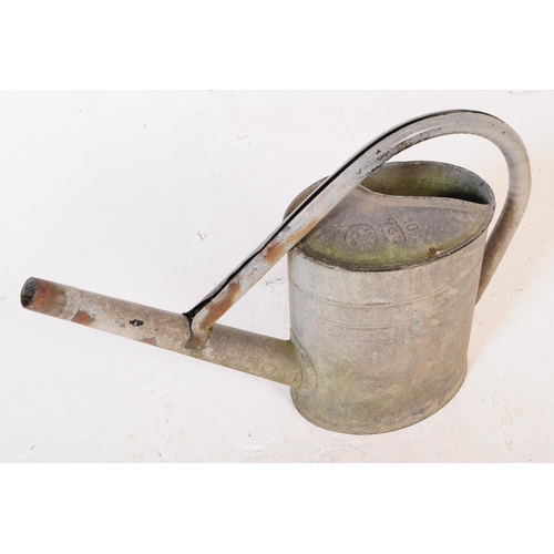 705 - A collection of mid 20th century galvanised bath/planters & watering cans. To include three oval gal... 