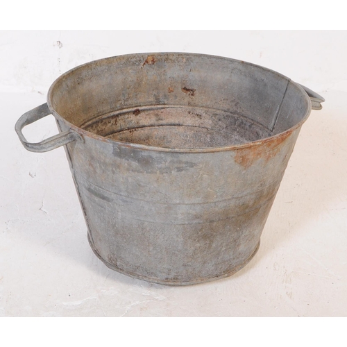 705 - A collection of mid 20th century galvanised bath/planters & watering cans. To include three oval gal... 