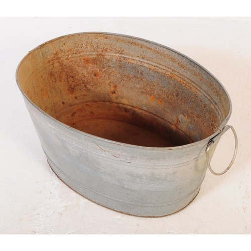 705 - A collection of mid 20th century galvanised bath/planters & watering cans. To include three oval gal... 