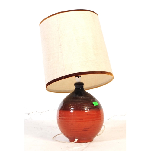 712 - A mid 20th century West German manner terracotta ceramic lamp. The lamp having a bulbous base with a... 