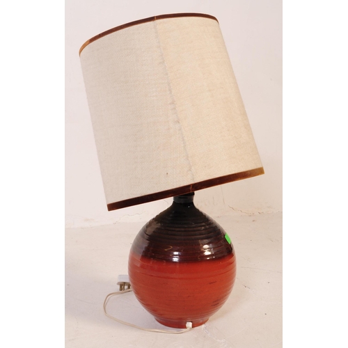 712 - A mid 20th century West German manner terracotta ceramic lamp. The lamp having a bulbous base with a... 