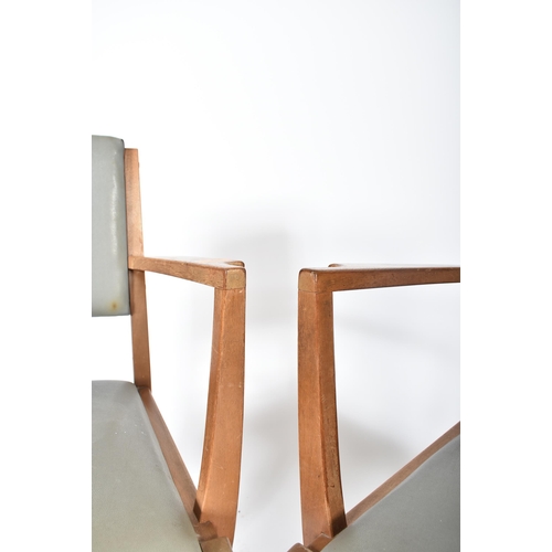 720 - Gordon Russell of Broadway - A pair of mid century oak framed carver armchairs. Each elbow chair hav... 