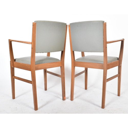 720 - Gordon Russell of Broadway - A pair of mid century oak framed carver armchairs. Each elbow chair hav... 