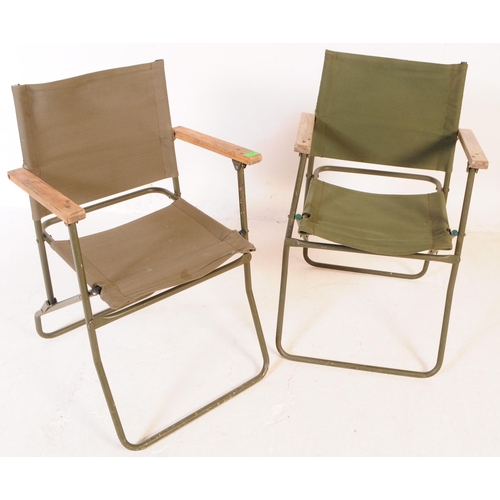 728 - A pair of mid 20th century metal and canvas folding military chairs. The chairs having bent painted ... 