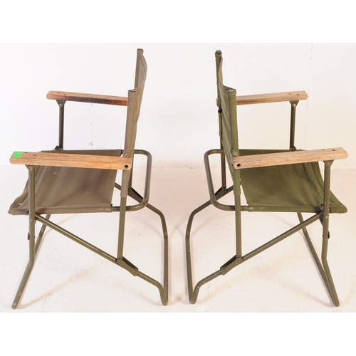 728 - A pair of mid 20th century metal and canvas folding military chairs. The chairs having bent painted ... 