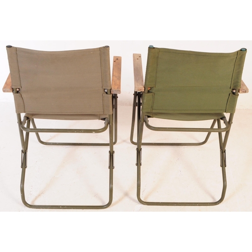 728 - A pair of mid 20th century metal and canvas folding military chairs. The chairs having bent painted ... 