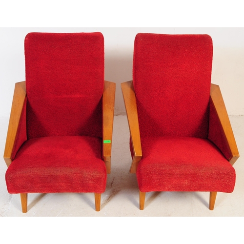 735 - A pair of mid 20th century circa 1950s oak framed lounge armchairs. The chairs having red boucle fab... 