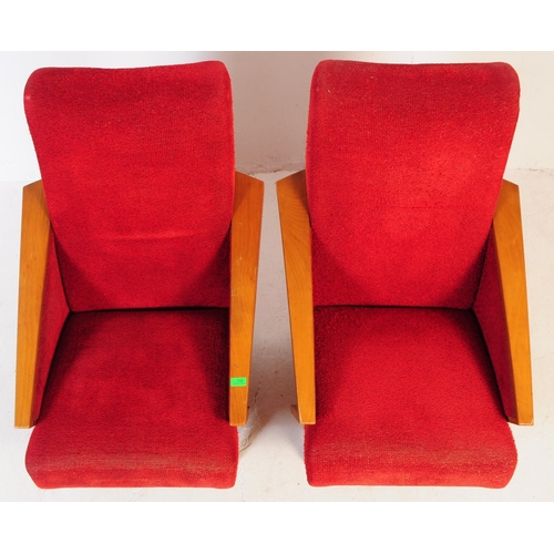 735 - A pair of mid 20th century circa 1950s oak framed lounge armchairs. The chairs having red boucle fab... 