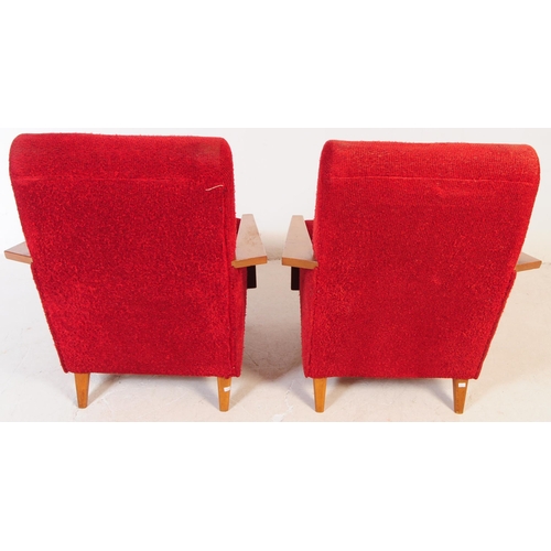 735 - A pair of mid 20th century circa 1950s oak framed lounge armchairs. The chairs having red boucle fab... 