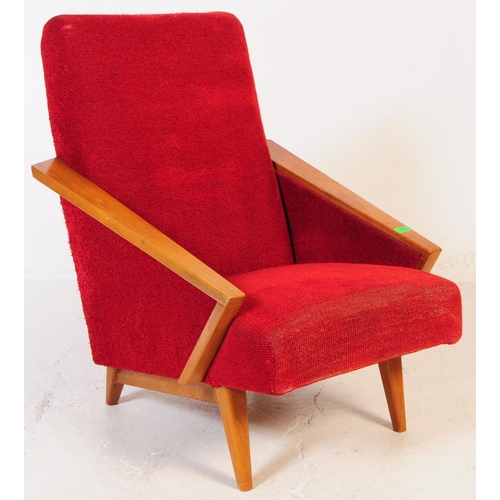 735 - A pair of mid 20th century circa 1950s oak framed lounge armchairs. The chairs having red boucle fab... 