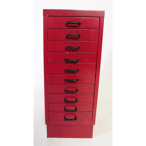 736 - British Modern Design - A mid century red colourway filing cabinet. Having a bank of shallow drawers... 