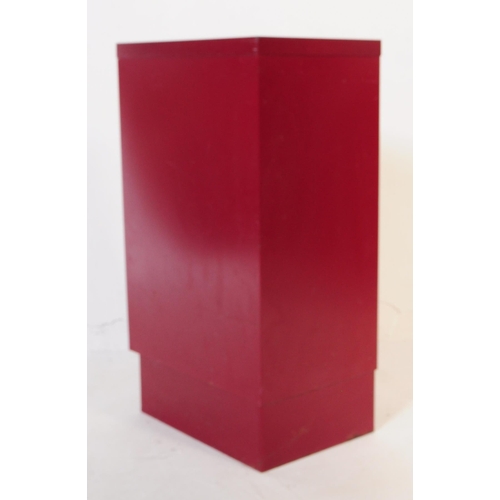 736 - British Modern Design - A mid century red colourway filing cabinet. Having a bank of shallow drawers... 