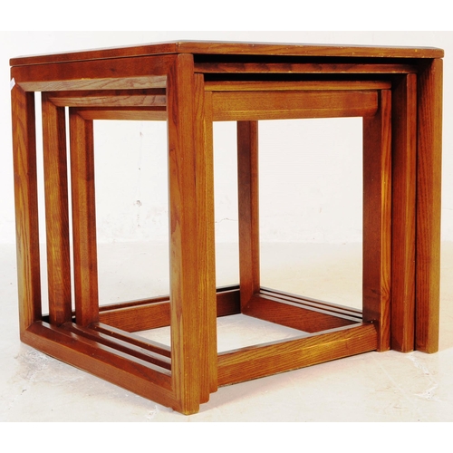 738 - G-Plan - A mid 20th century G Plan oak nest of side tables. The tables each of square form with beve... 