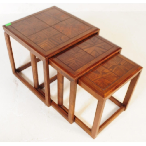 738 - G-Plan - A mid 20th century G Plan oak nest of side tables. The tables each of square form with beve... 