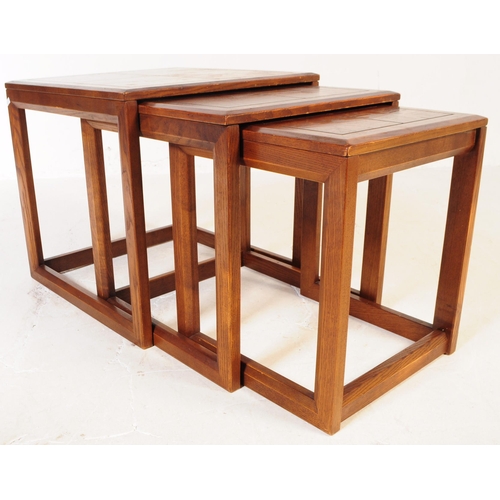 738 - G-Plan - A mid 20th century G Plan oak nest of side tables. The tables each of square form with beve... 