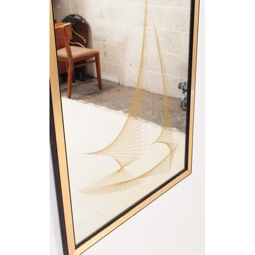 741 - A mid 20th century circa 1970s framed wall mirror. The mirror of rectangular form with gilt panellin... 