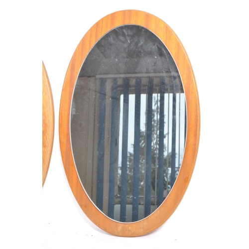 763 - Two matching retro mid 20th century circa 1960's teak framed wall hanging mirrors. Each having oval ... 