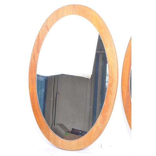 763 - Two matching retro mid 20th century circa 1960's teak framed wall hanging mirrors. Each having oval ... 