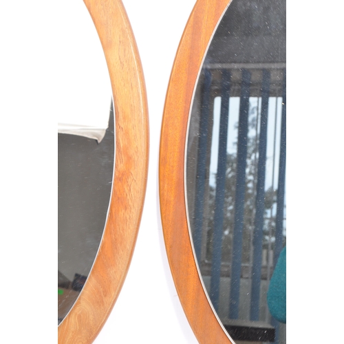 763 - Two matching retro mid 20th century circa 1960's teak framed wall hanging mirrors. Each having oval ... 