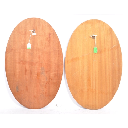 763 - Two matching retro mid 20th century circa 1960's teak framed wall hanging mirrors. Each having oval ... 