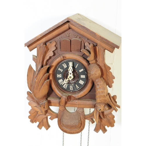 771 - Two mid century Black Forest German Bavarian wall hanging cuckoo clocks. Both having a carved detail... 