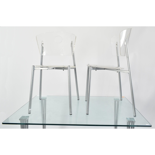 570 - A contemporary tempered glass & chrome rectangular dining table with chairs. The table having a rect... 