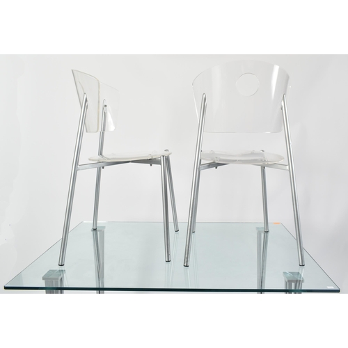 570 - A contemporary tempered glass & chrome rectangular dining table with chairs. The table having a rect... 