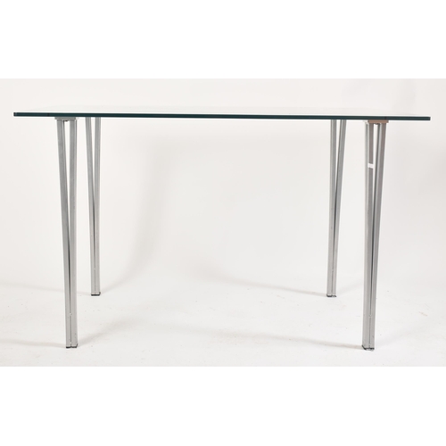 570 - A contemporary tempered glass & chrome rectangular dining table with chairs. The table having a rect... 