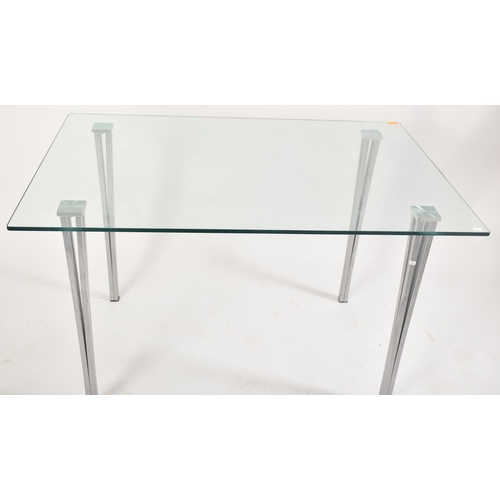 570 - A contemporary tempered glass & chrome rectangular dining table with chairs. The table having a rect... 