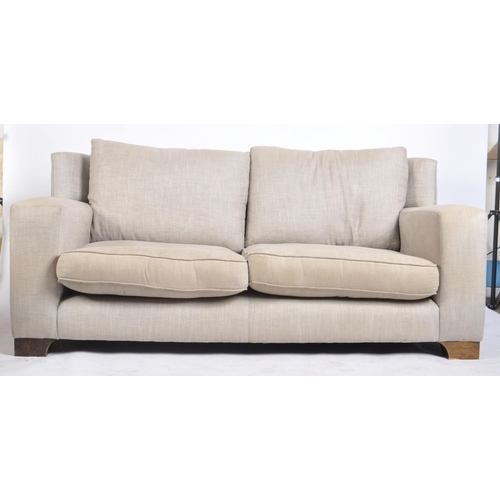 694 - Rossiters of Bath - a Contemporary Modern British Design two seater sofa settee. Having wingback bac... 