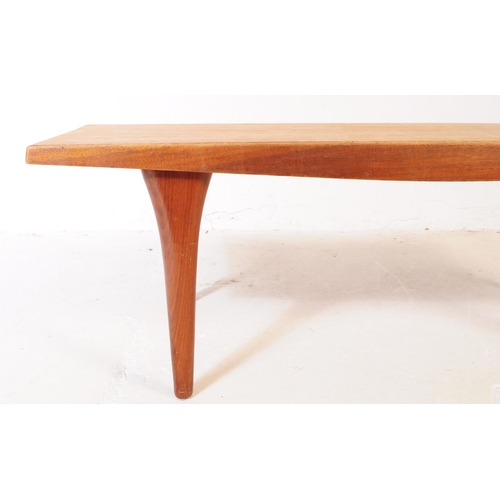 556 - A mid 20th century teak wood coffee table. The table of rectangular form, with shaped angled side, r... 