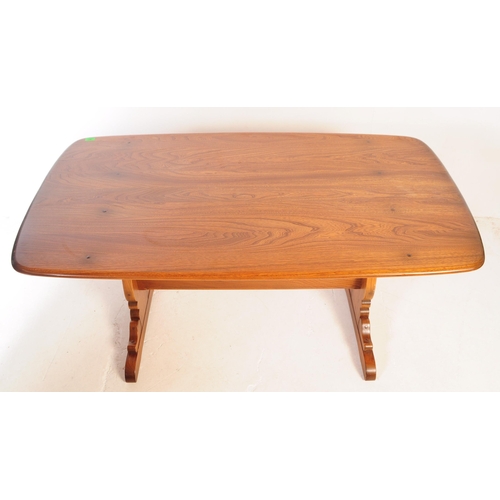 561 - A mid 20th century Ercol beech and elm refectory dining table and four windsor style chairs. The tab... 