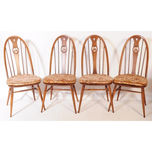 561 - A mid 20th century Ercol beech and elm refectory dining table and four windsor style chairs. The tab... 