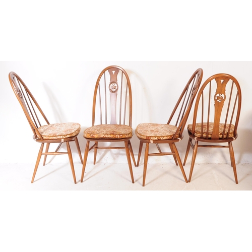 561 - A mid 20th century Ercol beech and elm refectory dining table and four windsor style chairs. The tab... 