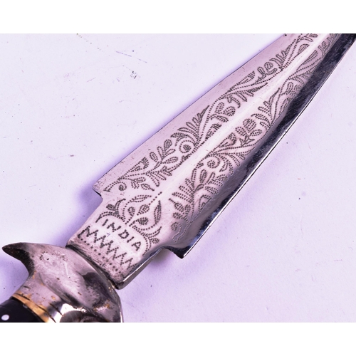 112 - A vintage Indian made dagger with a leather leg holster. The dagger with a round white metal pommel,... 