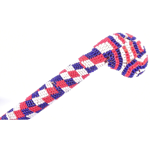 166 - A WWI First World War Officers walking cane decorated in Turkish red white and blue beadwork. Measur... 