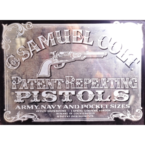 211 - A vintage 1970s Samuel Colt pistols advertising mirror set in a black surround and mounted into a wo... 